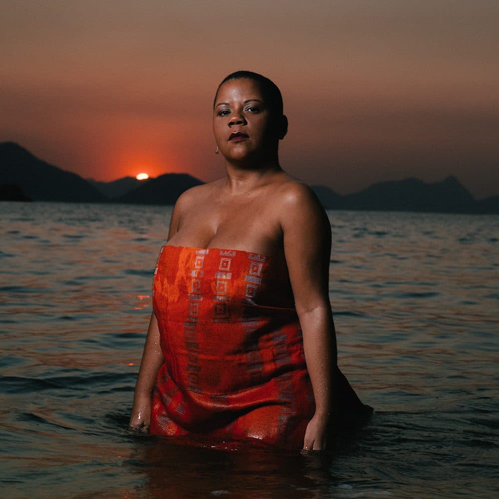 Ilessi standing in the sea at sunset