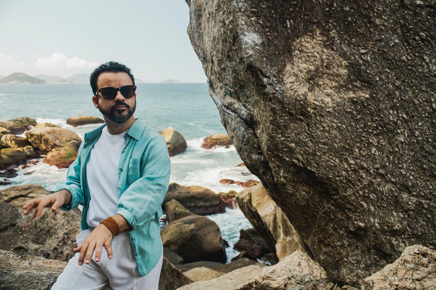 Marcelo Galter sitting on the rocks by the sea